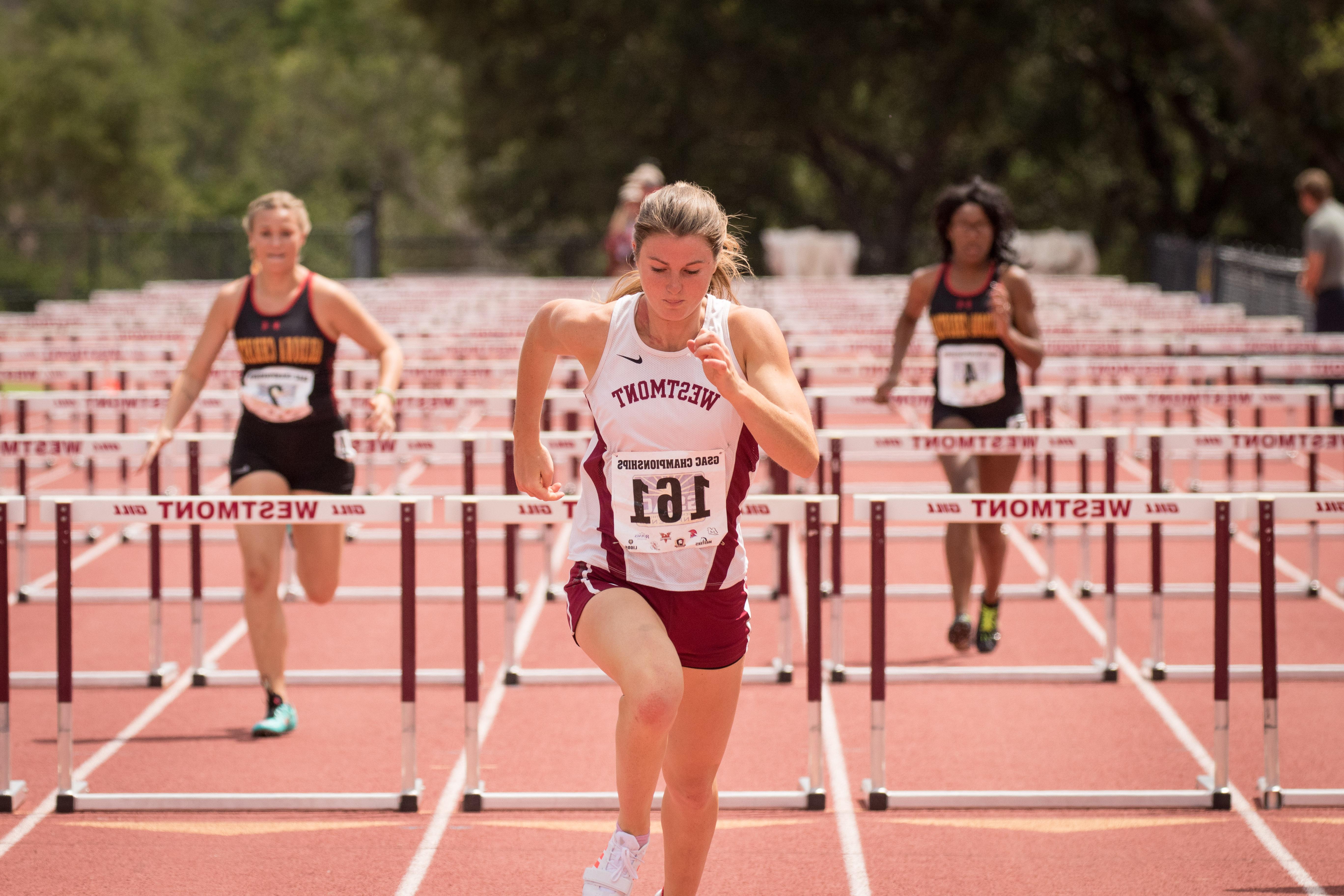 Student in the lead in a hurdle track race