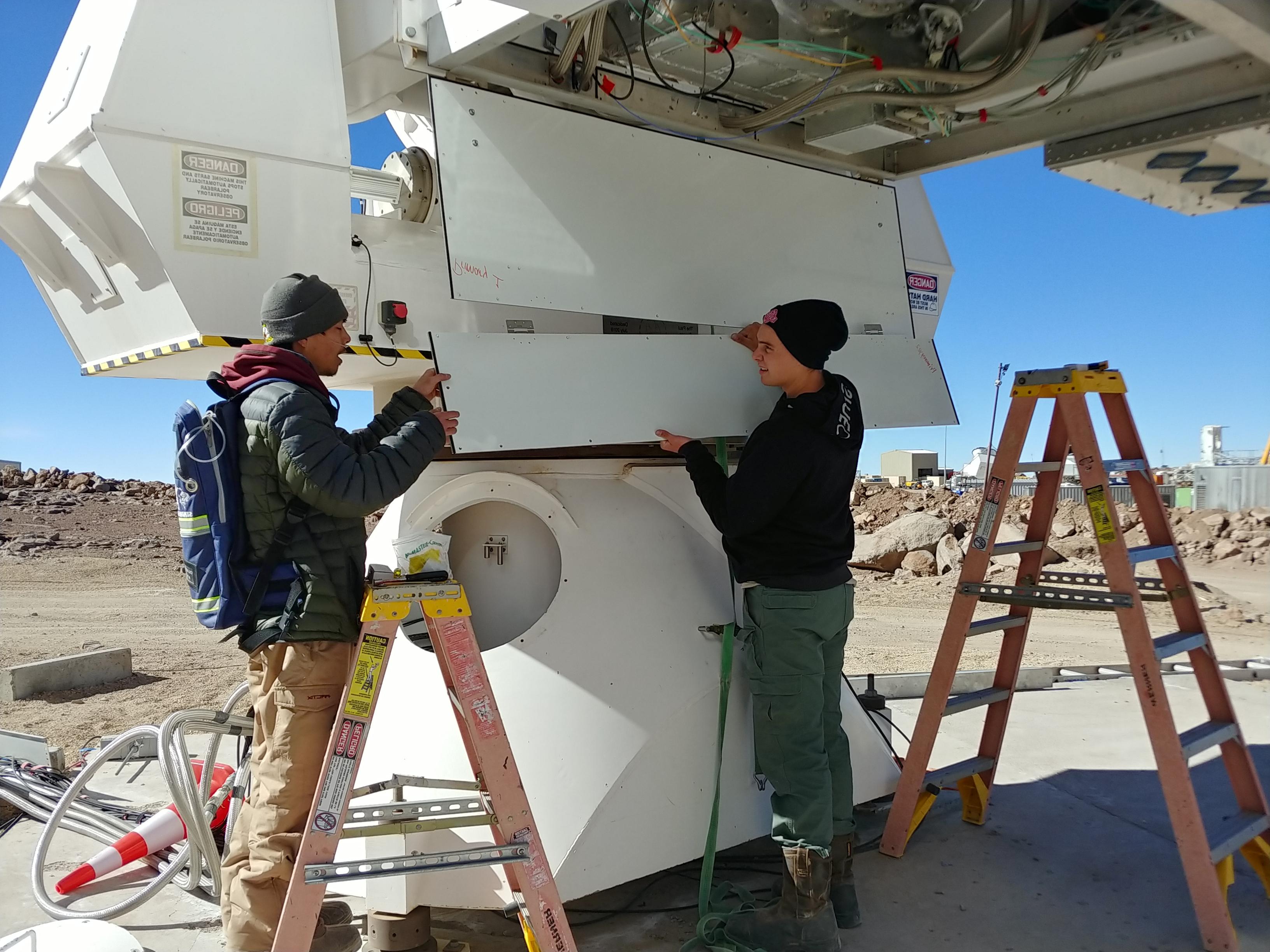 Westmont students Jacob Nelson and Michael Lew work on a telescope at the Simons Array in Chile
